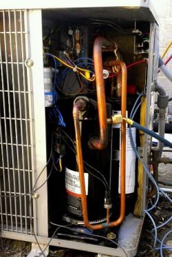 Open HVAC unit with compressor. |HVAC 101 | Air Conditioning Service